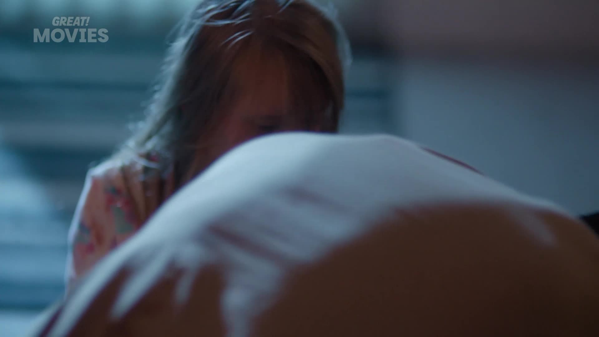 A young girl in pyjamas leans over a large, soft cushion. The GREAT! MOVIES logo appears in the top left corner.