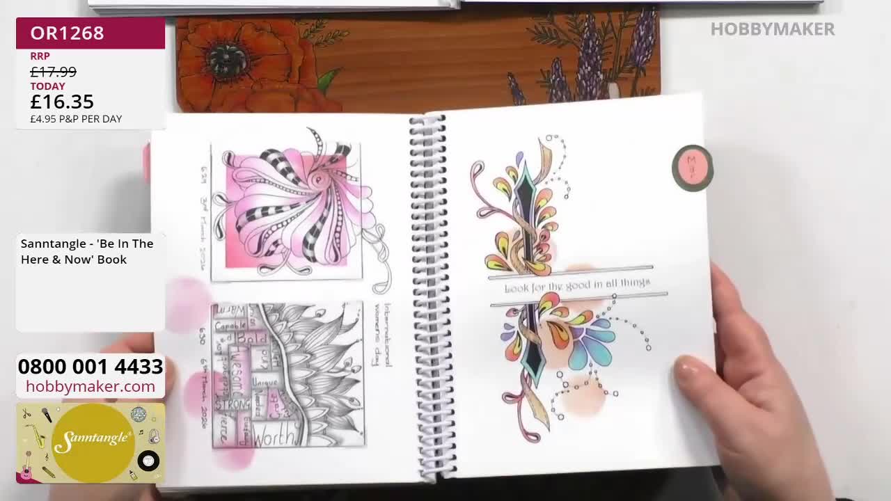 A hand turns the page of a spiral-bound book filled with intricate Zentangle-style art. The open pages display delicate ink drawings, some accented with soft pink and watercolour washes. A hand turns the page of a spiral-bound book filled with intricate Zentangle-style art. The open pages display delicate ink drawings, some accented with soft pink and watercolour washes.