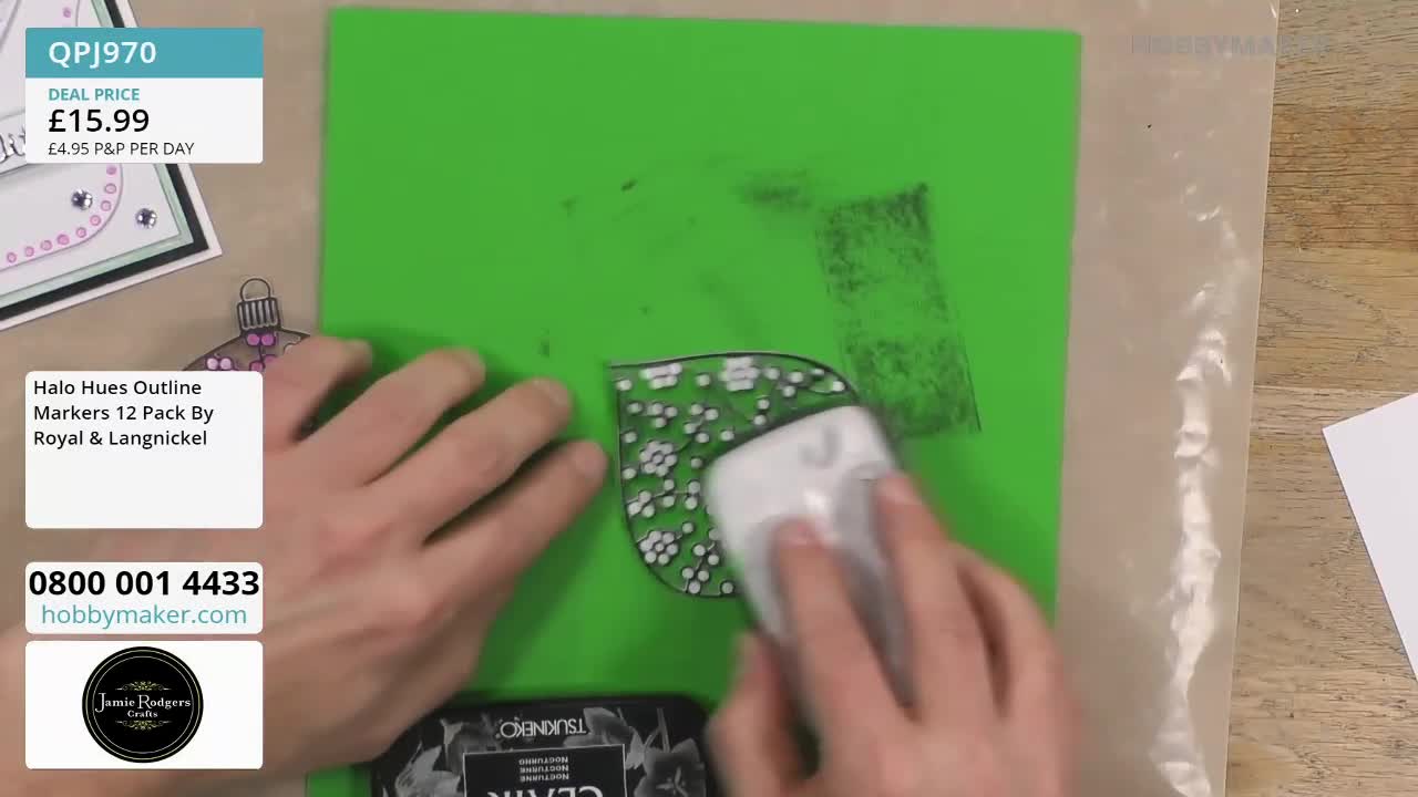 A white tool is being rubbed over a leaf outline on a bright green surface. The leaf is filled with tiny white dots, and a grey, smudged rectangle sits above it.