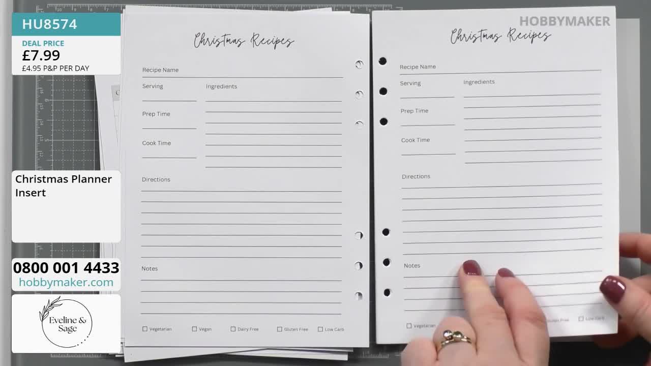 A hand with dark red nail polish points to the "Notes" section on a "Christmas Recipes" insert. The paper is part of a planner, likely from HobbyMaker, and is being held up for display.