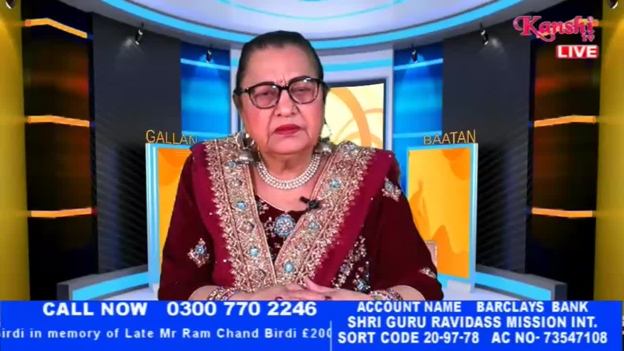 A woman in a richly embroidered maroon outfit speaks directly to the camera. The Kanshi TV logo is visible in the upper right corner.