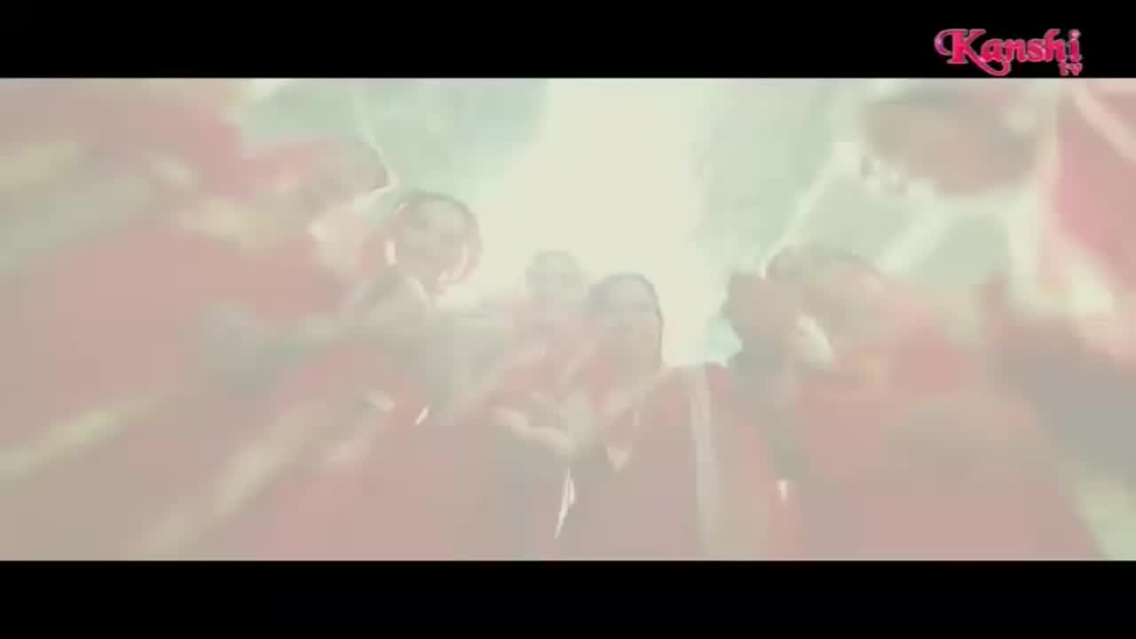 A group of people in red clothing are cheering and raising their hands. The Kanshi! logo appears in the top right corner.