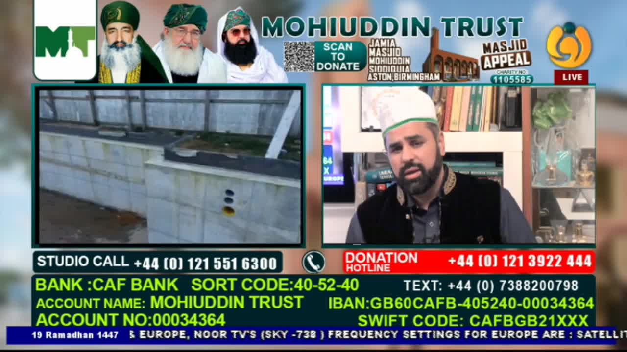 A man in a white kufi speaks earnestly on camera, with a video feed of a concrete structure behind him. The screen displays information for the Mohiuddin Trust's Masjid Appeal, including donation details for viewers in the UK.
