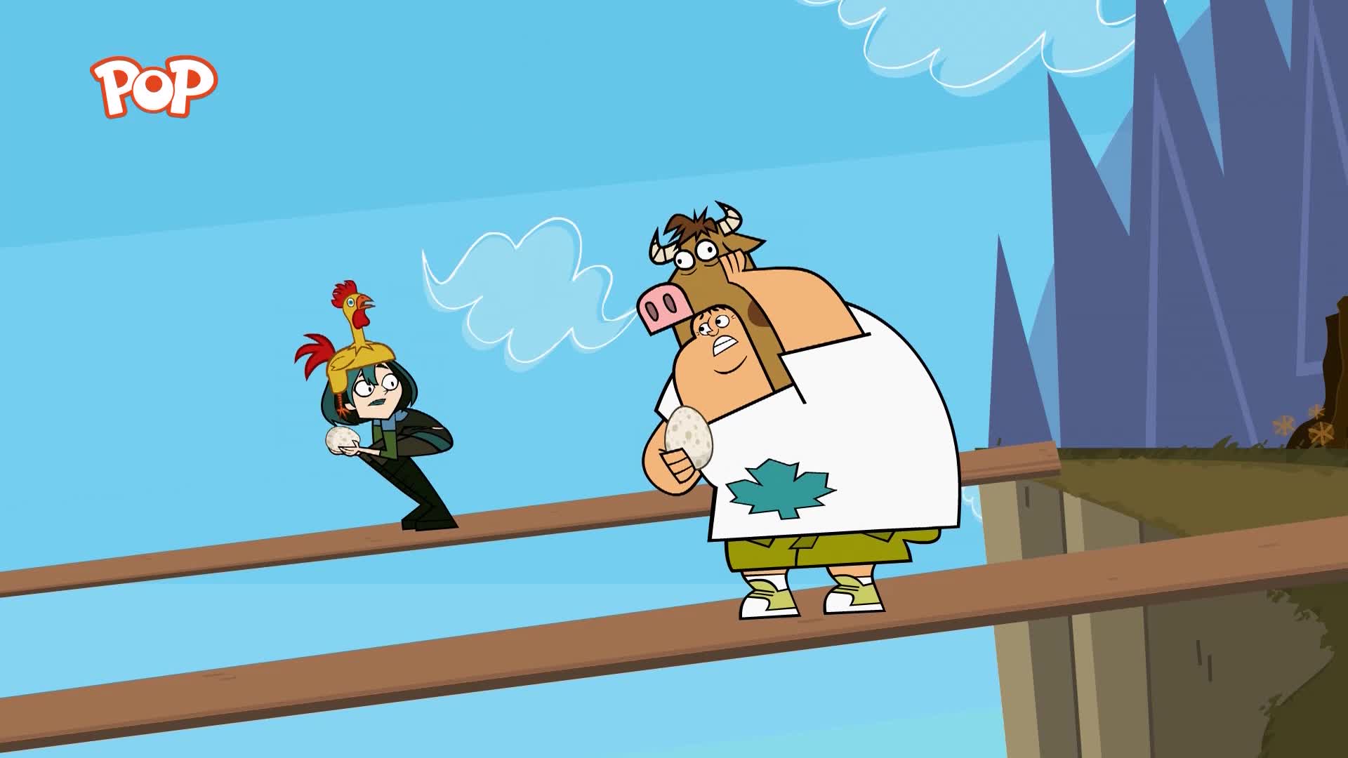 A girl in a chicken hat clutches an egg as she balances on a narrow plank. Beside her, a boy in a cow costume looks terrified, also holding an egg.
