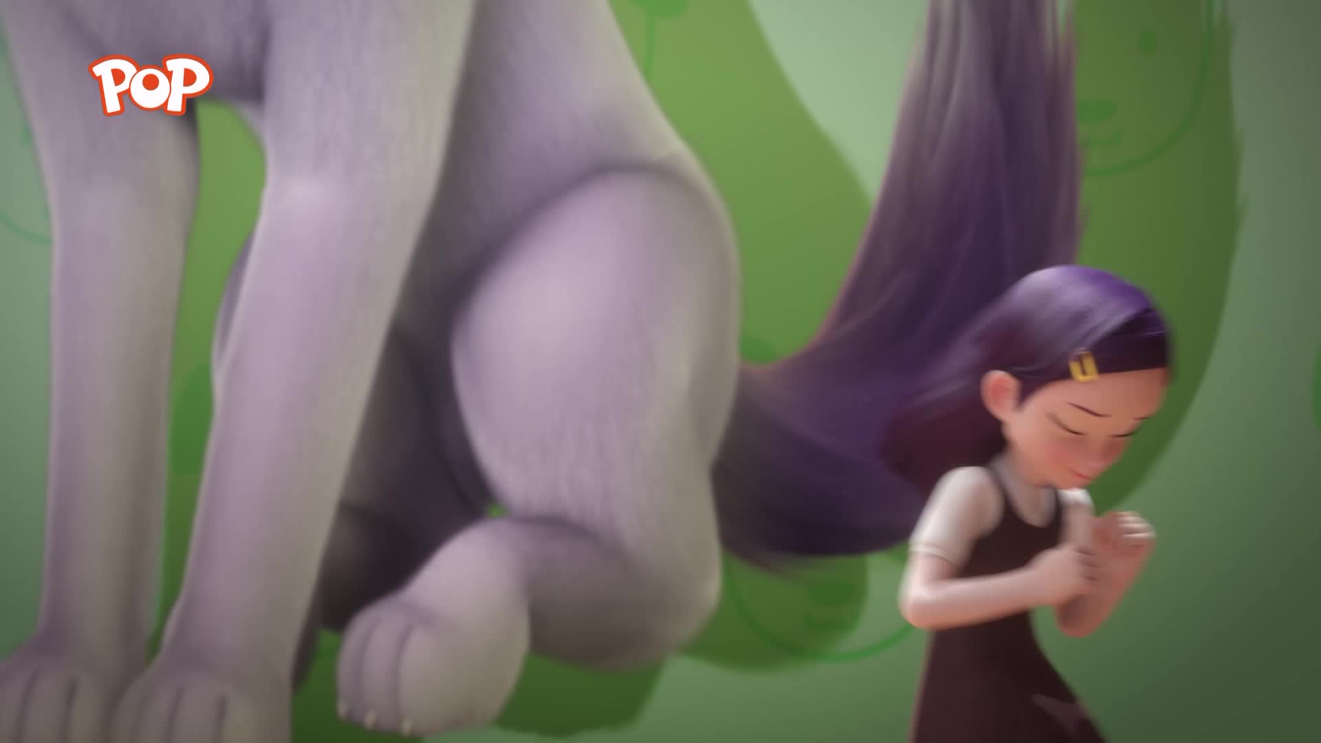 A large, grey creature's legs are planted firmly on the ground. A young girl with dark hair and a black dress is looking down, her hands clasped together.