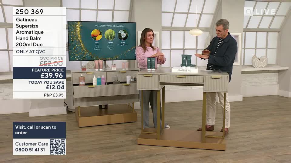 A man demonstrates Gatineau hand balm on his hand, while a woman stands nearby. The QVC price of the supersize duo is displayed on screen.