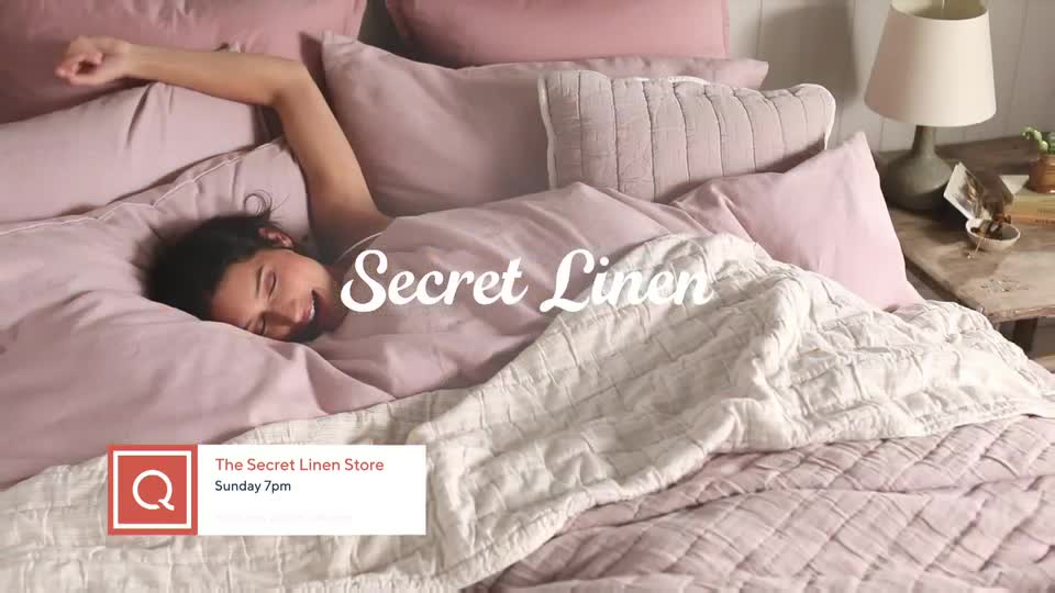 A young woman stretches languidly in a bed piled high with soft pink linens. The QVC Extra logo indicates this is part of their programming, likely promoting The Secret Linen Store airing Sunday at 7pm. A young woman stretches languidly in a bed piled high with soft pink linens. The QVC Extra logo indicates this is part of their programming, likely promoting The Secret Linen Store airing Sunday at 7pm.