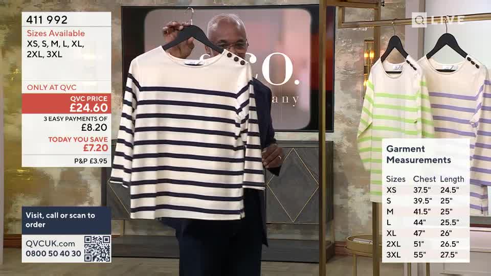 A man holds up a cream and navy striped long-sleeved top. Beside it, two other striped tops, one in cream and lime green, the other in cream and lavender, hang on display. A man holds up a cream and navy striped long-sleeved top. Beside it, two other striped tops, one in cream and lime green, the other in cream and lavender, hang on display.