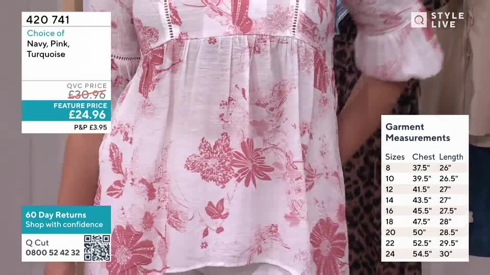 A woman stands in a white blouse with a pink floral print, showcasing the garment's details. A QVC overlay displays product information and garment measurements.