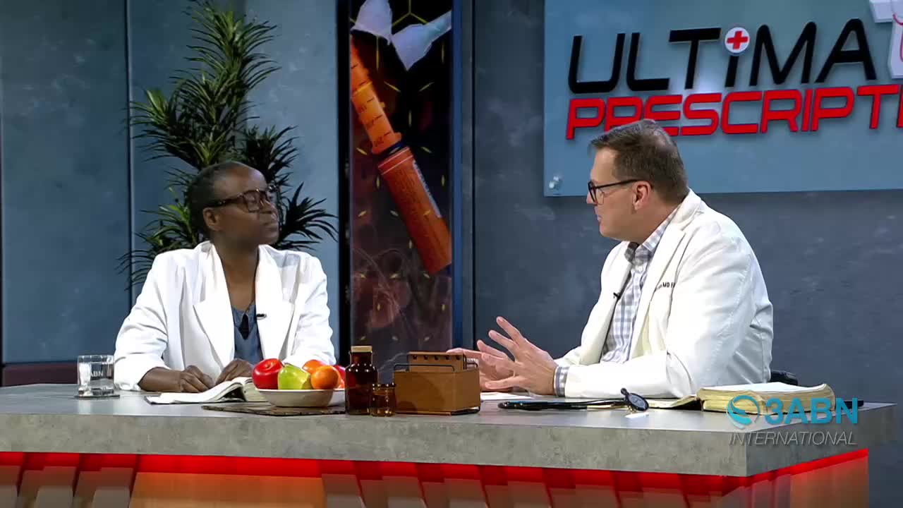 Two people in white coats sit at a table, discussing something. A 3ABN International logo is visible on the right side of the table.