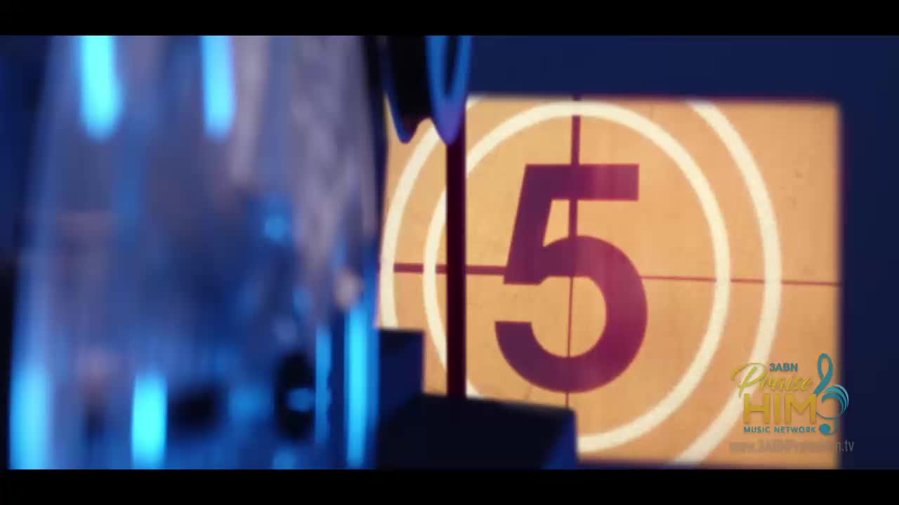 A countdown clock displays the number five in a retro style, set against a warm yellow backdrop. The 3ABN Praise Him Music Network logo is visible in the lower right corner.
