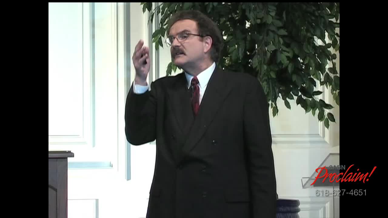 A man in a dark suit gestures emphatically, his right hand raised. The logo for 3ABN Proclaim! Network is visible in the corner.
