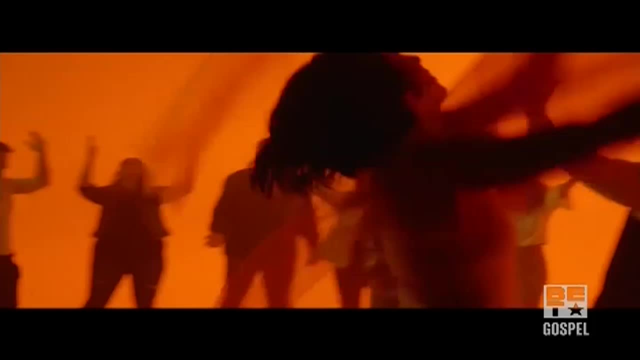 Silhouetted figures move in front of a bright orange backdrop, arms raised in worship. The BET Gospel logo is visible in the corner.
