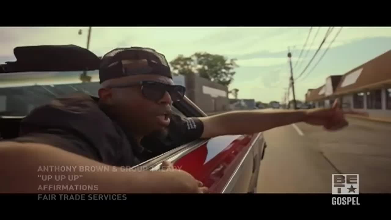 A man in sunglasses leans out of a red convertible, pointing his thumb up. The BET Gospel logo sits in the corner, and the background shows a typical American street scene.
