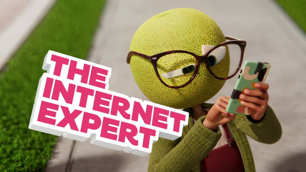 A cantaloupe-headed character, wearing glasses, stares at a phone. The words "The Internet Expert" float in front.

