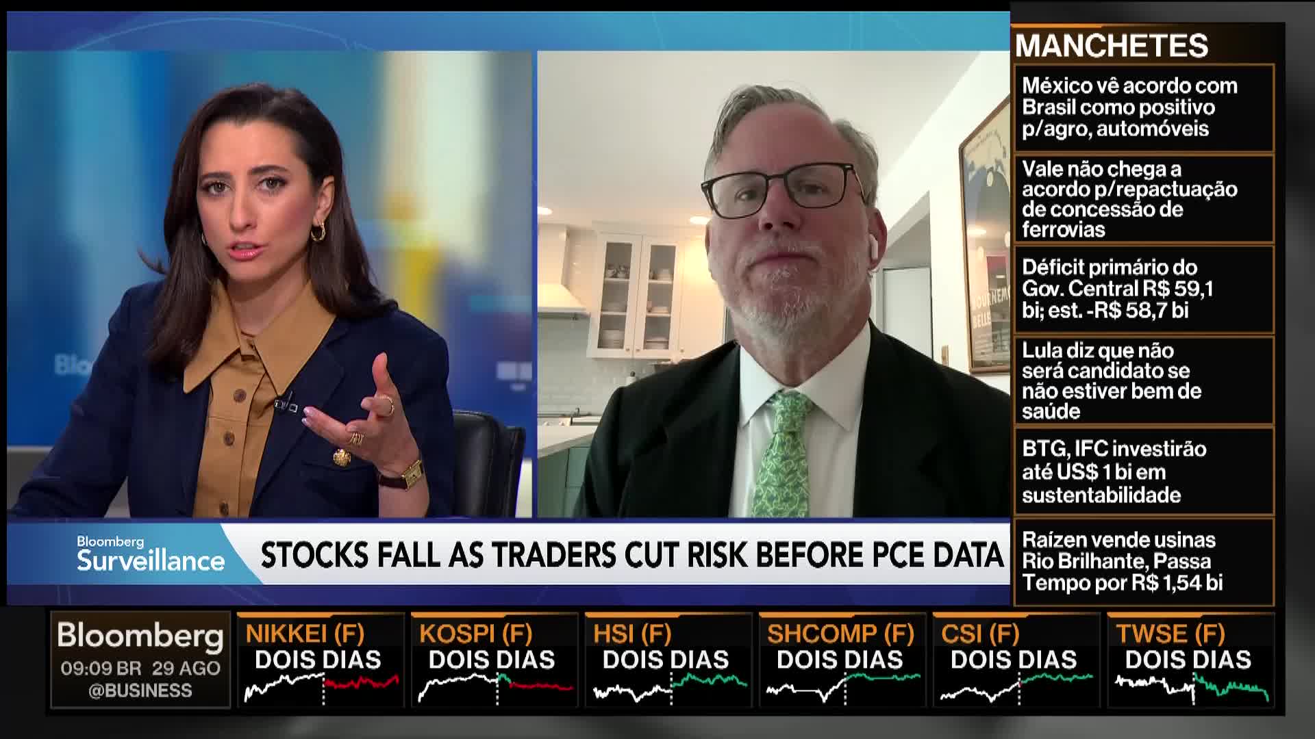 On Bloomberg TV, a woman gestures emphatically while speaking, her co-host listens intently from a remote location. The chyron reads "Stocks Fall as Traders Cut Risk Before PCE Data."
