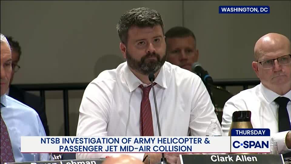A man in a white shirt and red tie speaks into a microphone, framed by other men seated at a table. The C-SPAN logo and a banner about an NTSB investigation are visible on the screen.
