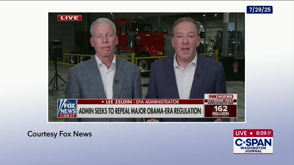 Two men in suits stand in front of a red truck, speaking into microphones. A Fox News banner at the bottom of the screen announces a story about an Obama-era regulation, while the C-SPAN Washington Journal logo is visible in the corner.
