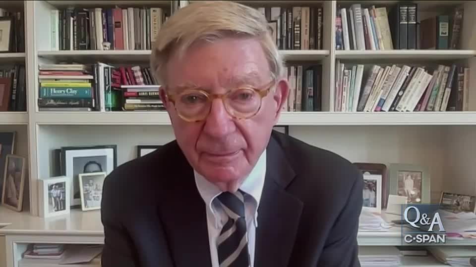 A man in a dark suit and glasses is centered, looking directly at the camera. Behind him, a bookshelf is filled with books, and the C-SPAN logo appears in the bottom right corner.
