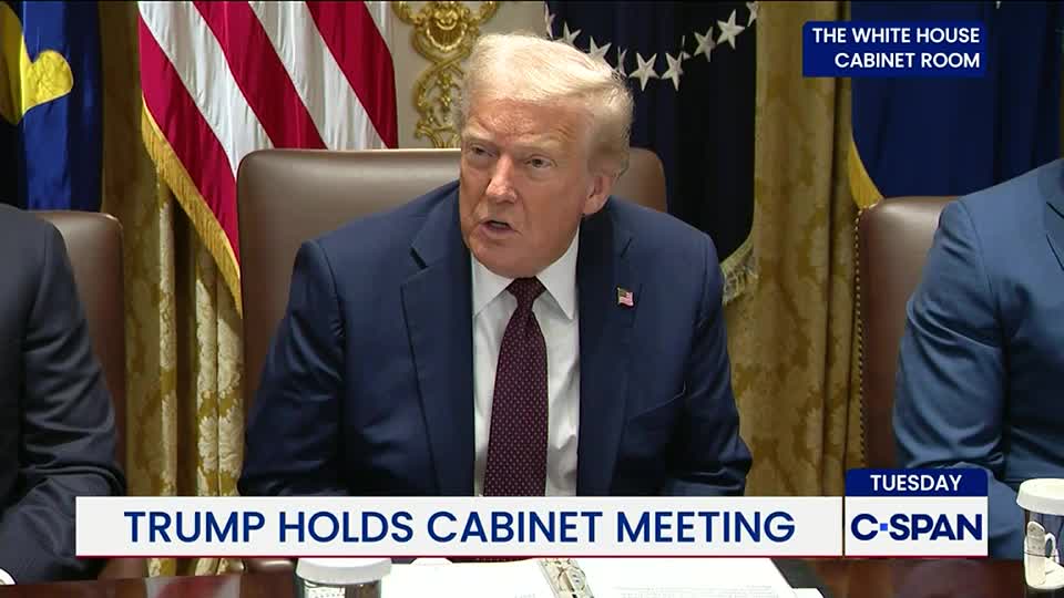 Trump, in a dark suit and burgundy tie, is speaking at a table in the White House Cabinet Room, as broadcast on C-SPAN. The American flag is visible in the background, and the chyron states the meeting is taking place on Tuesday.
