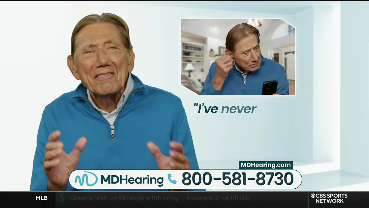 On CBS Sports Network USA, a man in a blue sweater gestures emphatically, while a smaller image shows him putting in a hearing aid. The MDHearing.com phone number is displayed on the screen.

