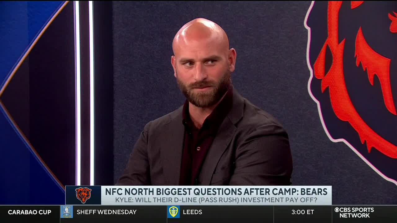 A man with a shaved head and a beard is seated, looking directly at the camera on CBS Sports Network USA. The lower third of the screen poses a question about the Chicago Bears' defensive line.
