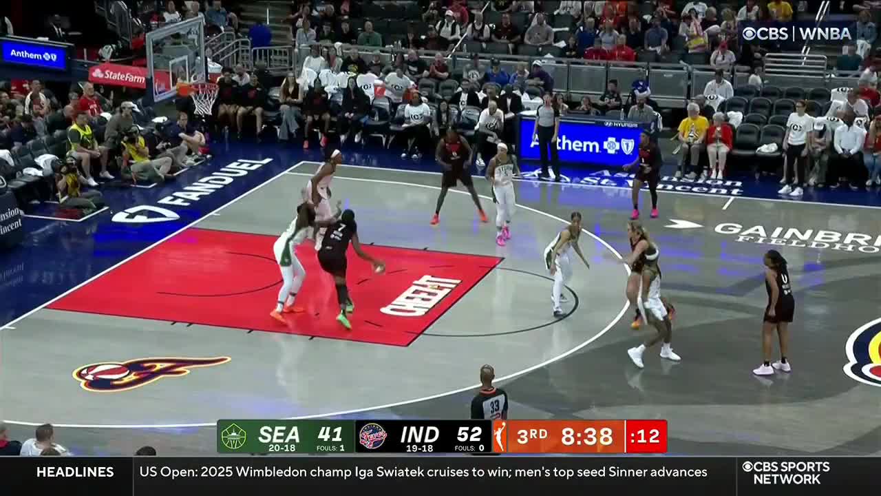 A player in black leaps toward the basket, ball in hand, as two defenders in white and green try to block her shot. The clock shows just over eight minutes left in the third quarter of the CBS Sports Network USA game.
