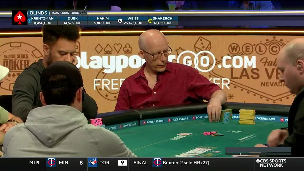 A player in a red shirt studies the cards on the table, his hand hovering over his chips. The CBS Sports Network USA logo is visible in the corner, broadcasting from Las Vegas.
