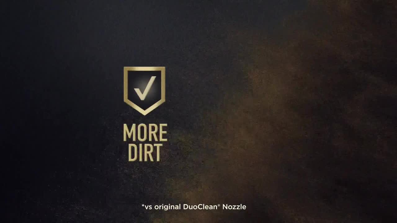 A gold shield with a checkmark sits above the words "MORE DIRT." Below, in smaller text, it says "vs original DuoClean® Nozzle."
