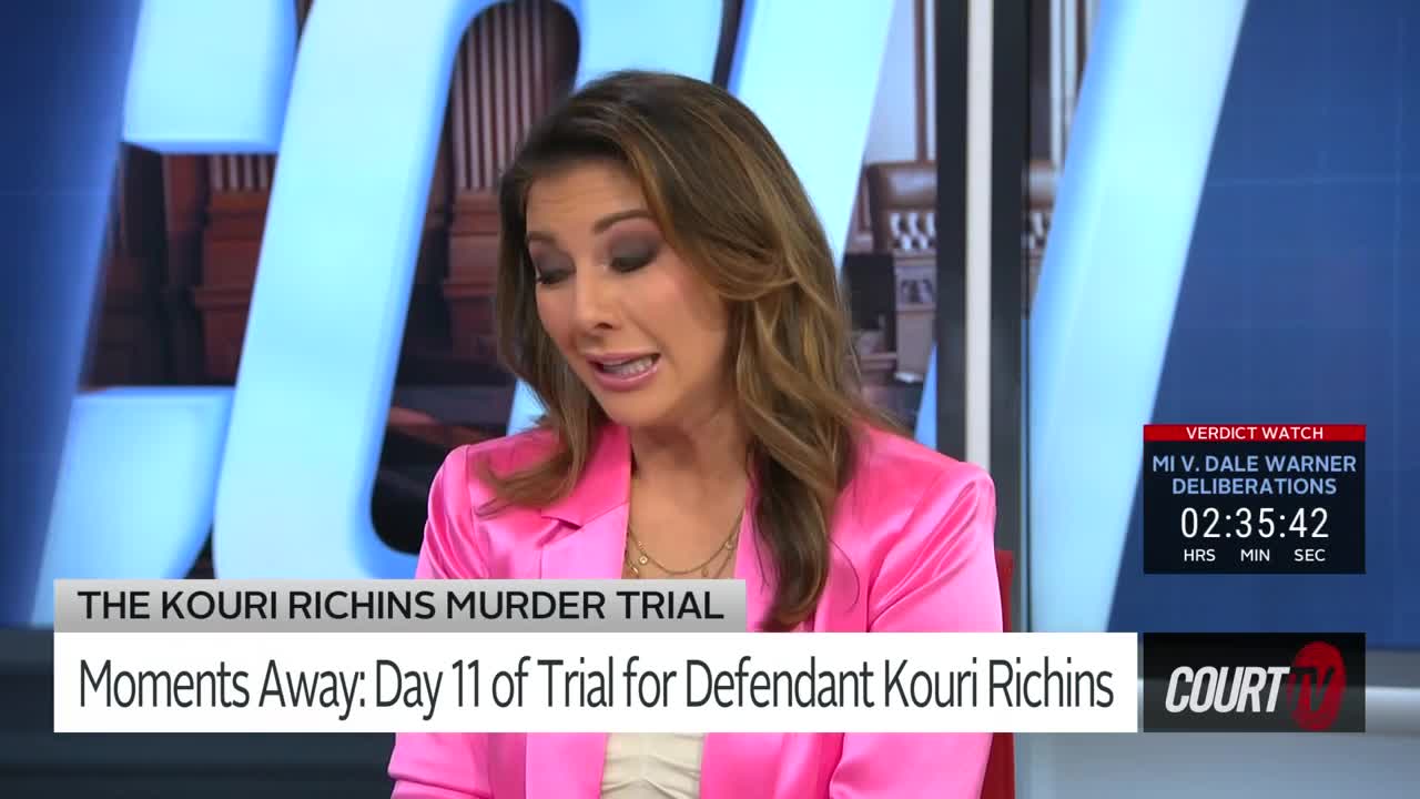 The woman in the bright pink jacket is speaking, her expression earnest. A digital clock on the right side of the screen counts down the hours, minutes, and seconds.