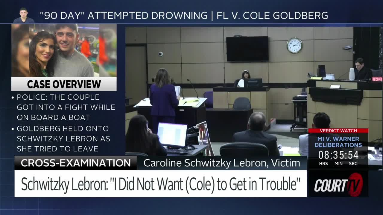 A woman in a purple suit stands at a lectern, addressing the court. Across the room, a judge presides while a jury deliberates.