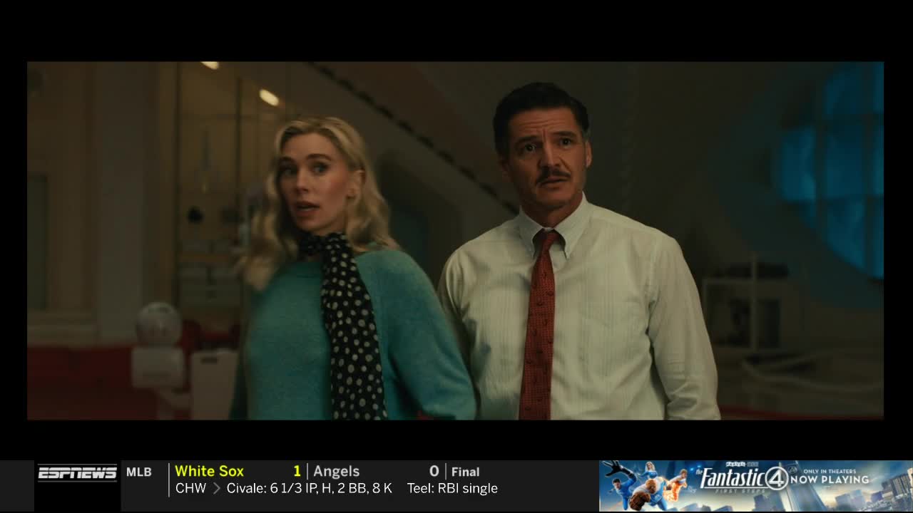 A woman in a teal sweater and a man in a white shirt with a red tie are walking, looking concerned. The ESPNews banner at the bottom shows the White Sox playing the Angels.
