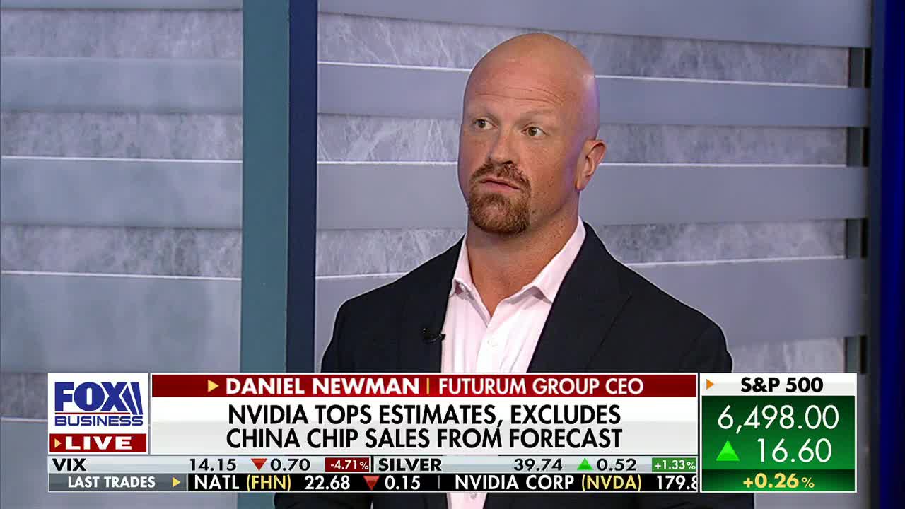A man in a suit jacket is talking, his gaze fixed slightly off-camera on Fox Business Network. Below him, a ticker displays stock market information, including the S&P 500.
