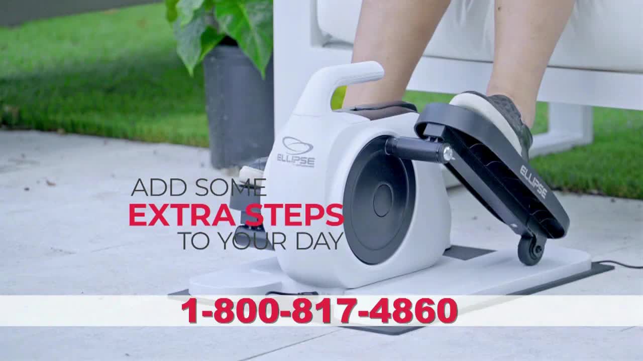 A person's foot in a sneaker is pushing down on the elliptical machine's pedal. The device is white, with the word "ELLIPSE" printed on the moving part.

