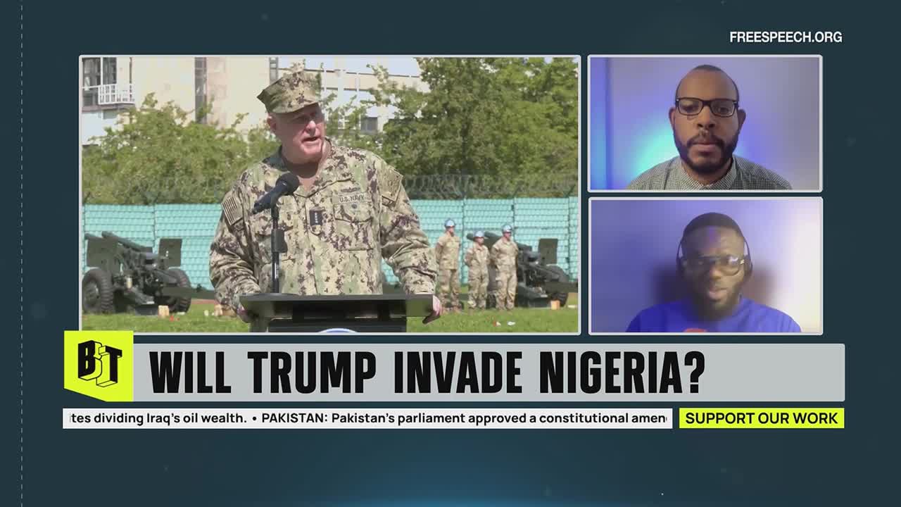 A man in a military uniform speaks from behind a podium, with other soldiers and artillery pieces in the background. The Free Speech TV broadcast features two commentators reacting to the speaker.
