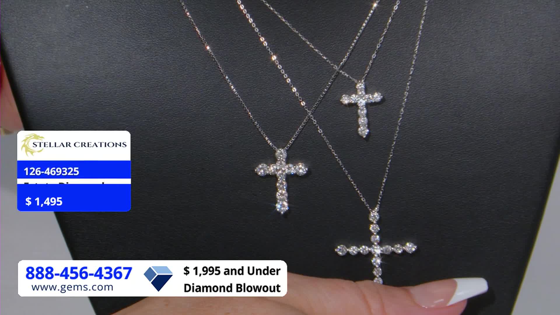 Three diamond-studded cross pendants hang against a black backdrop, with a hand holding the lowest one. The Gem Shopping Network's "$1,995 and Under Diamond Blowout" is advertised on the screen.

