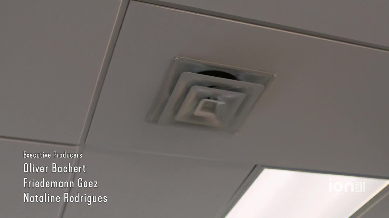 A white air vent sits recessed in the ceiling, its square shape framed by the grid. Below, credits for the ION Plus show roll by.
