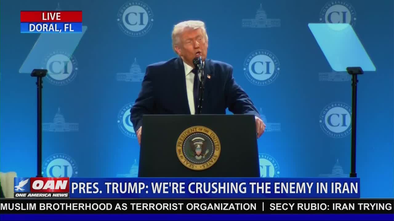President Trump stands at a podium in Doral, Florida, speaking to a crowd. A graphic from One America News Network displays his statement: "PRES. TRUMP: WE'RE CRUSHING THE ENEMY IN IRAN."