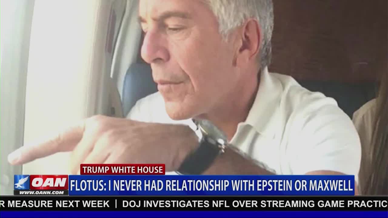 A man with gray hair points his finger toward the left, his gaze fixed on something outside the frame. A news chyron from One America News Network scrolls across the bottom of the screen, reporting on the White House.