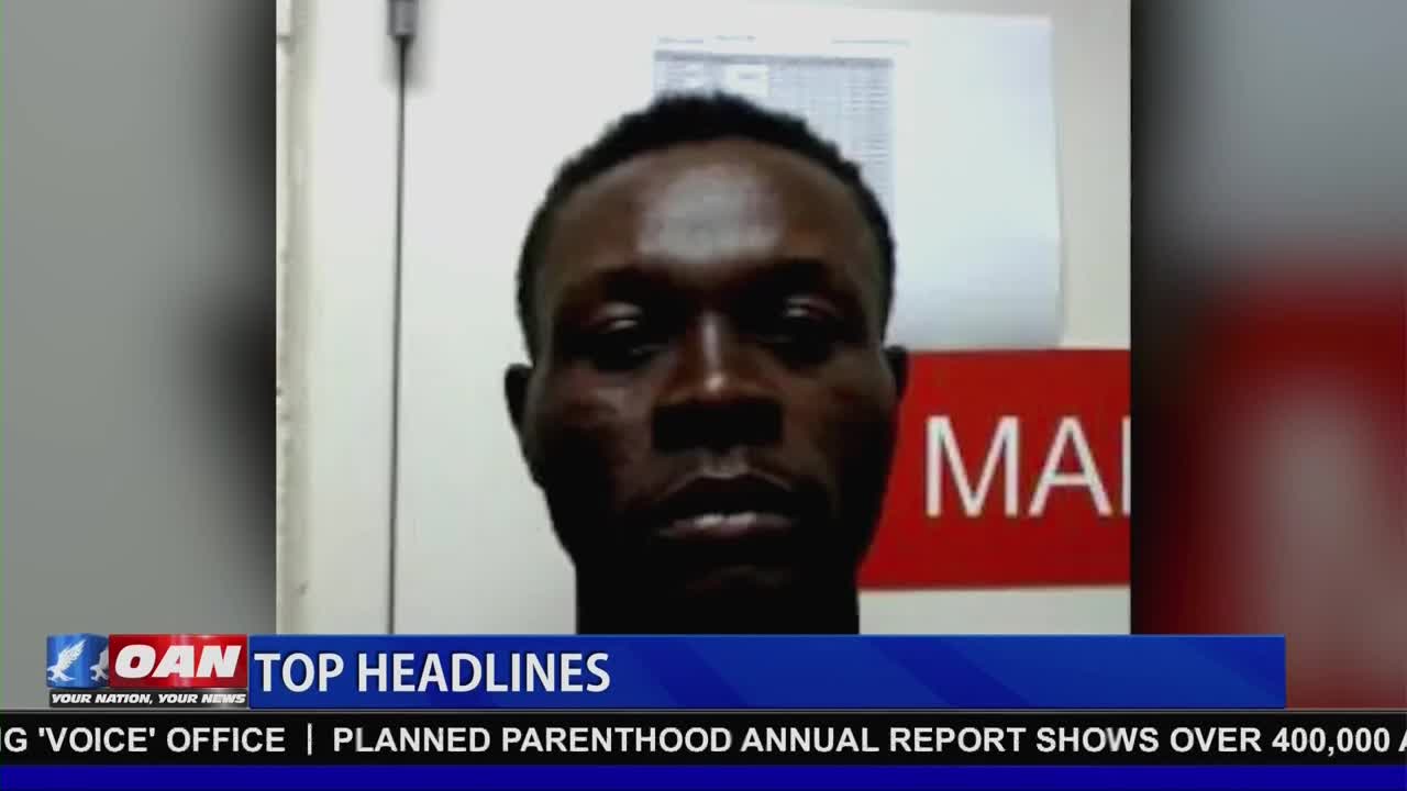 A man's face fills the screen, his expression unreadable. Below him, a banner for One America News Network displays "TOP HEADLINES."