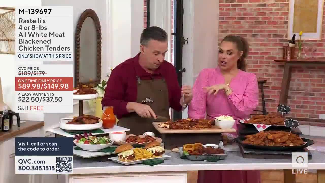 A man in a maroon shirt and apron slices into a platter of blackened chicken tenders. Beside him, a woman in a pink top gestures animatedly while explaining something about the food.
