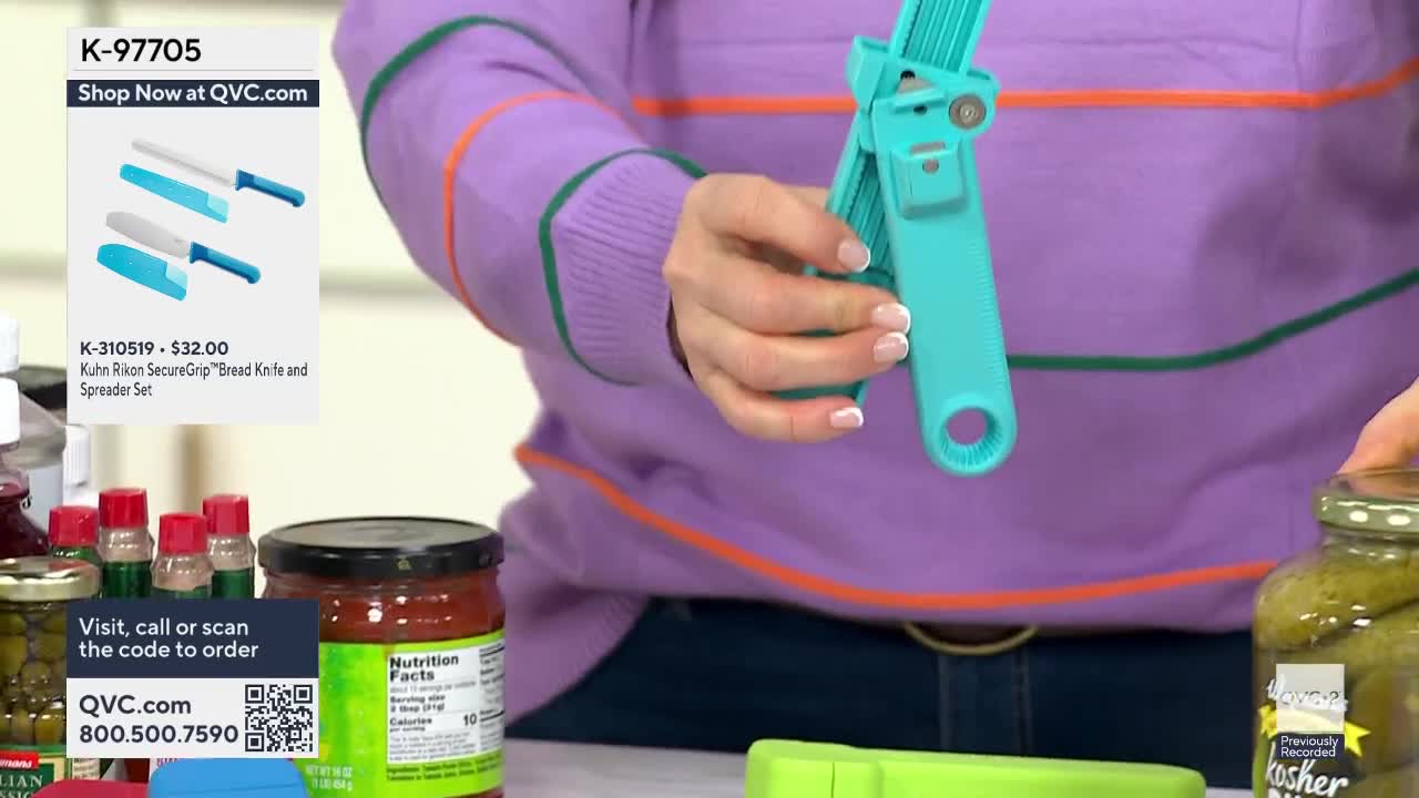 A teal-colored can opener is being demonstrated on QVC2. Beside it, a jar of pickles sits ready for opening.