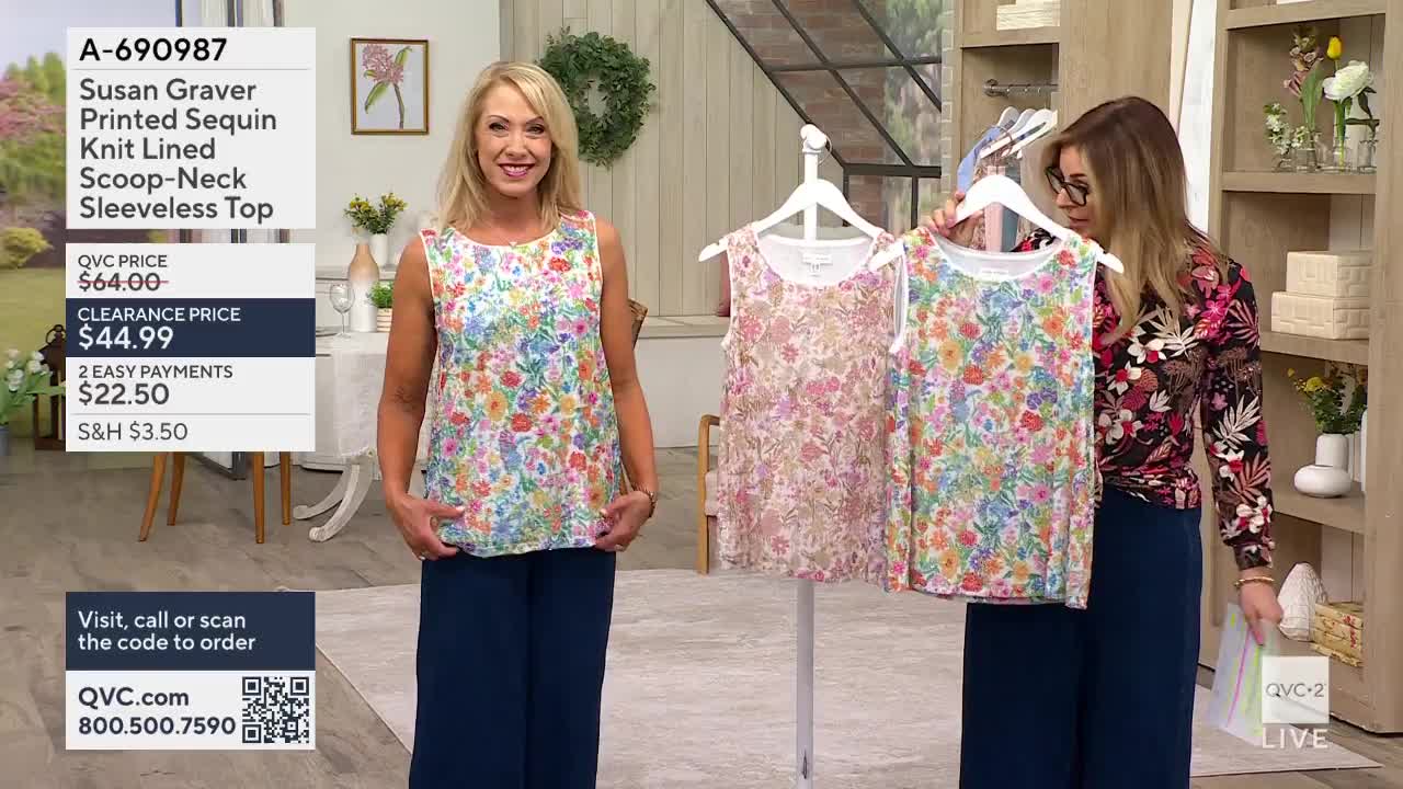 A woman in a floral tank top stands with her hands on her hips, while another woman holds up two more floral tops on hangers. The QVC2 logo is visible in the lower right corner.