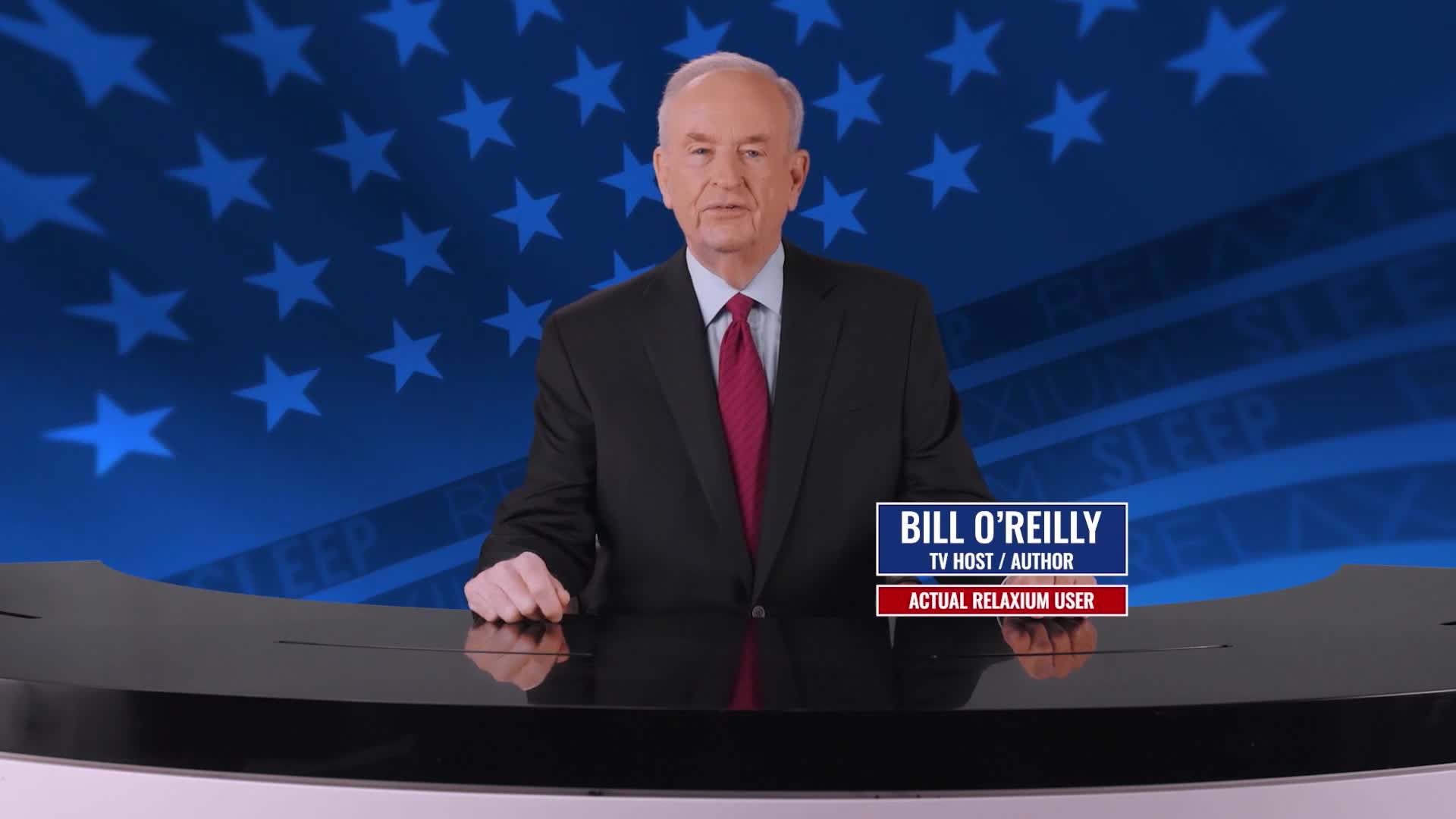Bill O'Reilly stands behind a desk, a familiar sight on American television. He's dressed in a suit and tie, ready to deliver his thoughts.