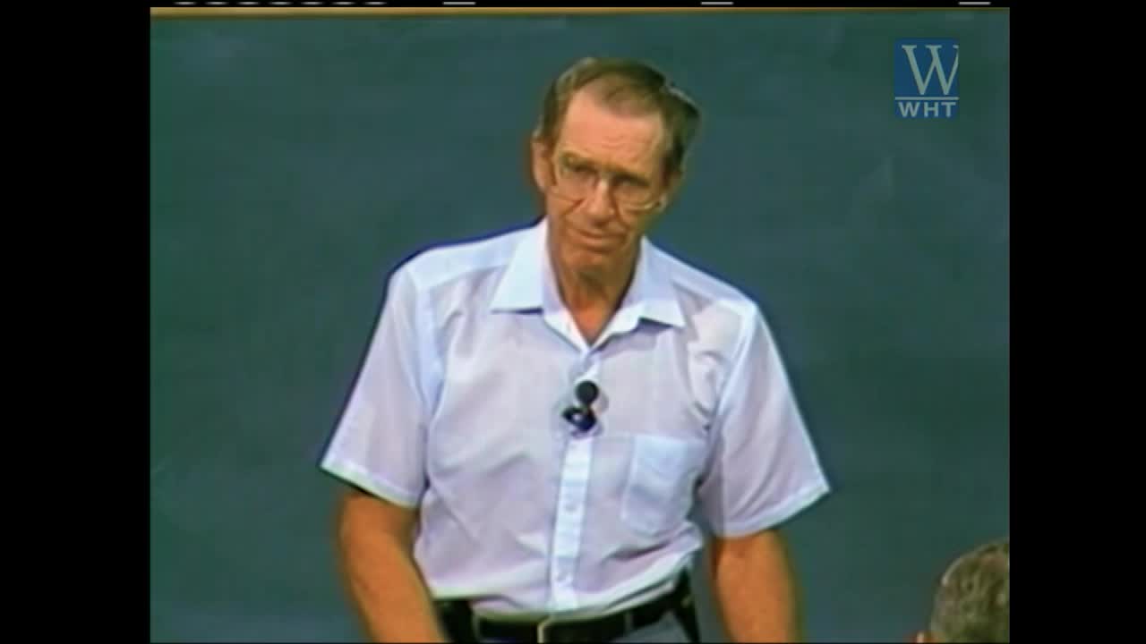 A man in a light blue button-down shirt speaks into a microphone clipped to his collar. The World Harvest TV logo appears in the upper right corner.