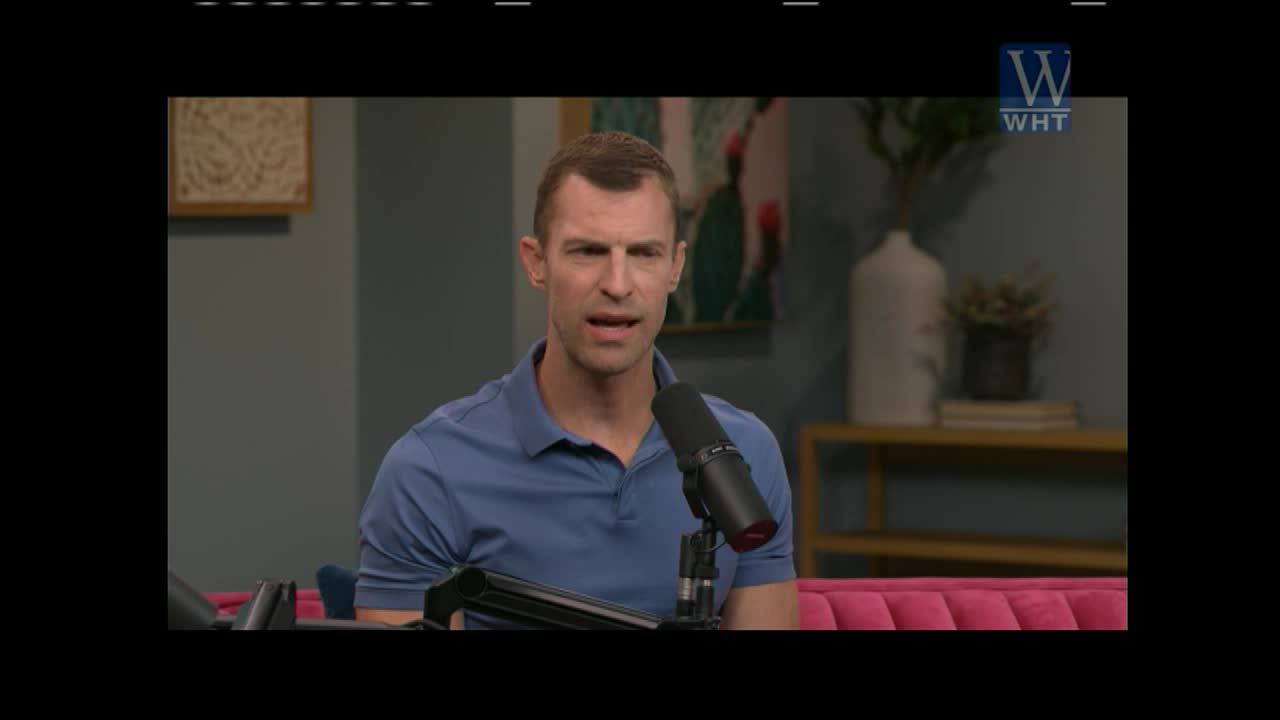 A man in a blue polo shirt speaks into a microphone. The World Harvest Television logo appears in the upper right corner.