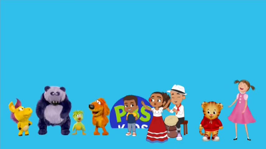 A collection of cartoon characters and puppets stand together against a bright blue backdrop. A group of children and musicians play music, while other characters stand nearby.

