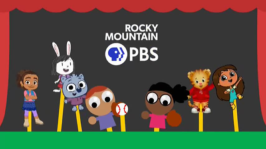 A group of cartoon characters, each on a yellow stick, are arranged on a green stage. The Rocky Mountain PBS logo is centered above them.
