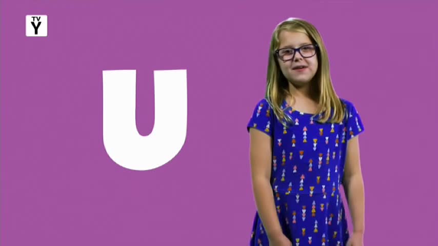 A young girl in a blue dress stands in front of a large white "U" on a purple background. The "TV Y" logo, likely from 10 Bold in Australia, is in the top left corner.
