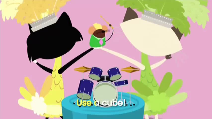 Two cat-like figures, one black and one cream, flank a drum set, each holding their arms up. A tiny creature with a drumstick is poised above the drums, and the words "Use a cube!" appear below.
